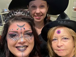 Employees Dressed as Witches Pose for a Selfie